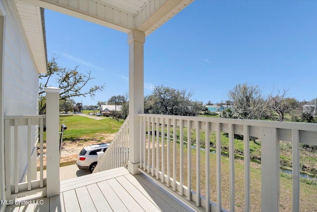 wooden deck with a yard