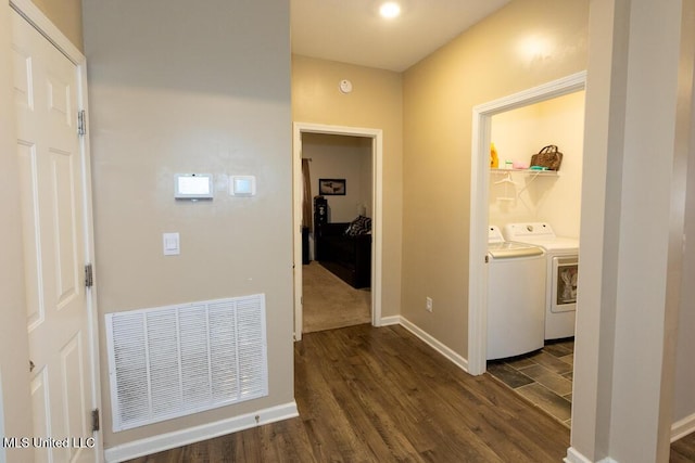 hallway with dark hardwood / wood-style floors and washing machine and clothes dryer