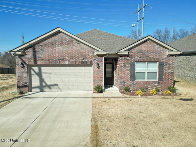 view of front of property with a front yard and a garage