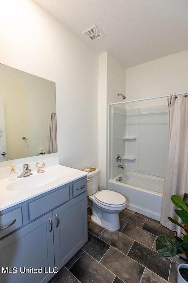 full bathroom featuring toilet, vanity, and shower / bathtub combination with curtain