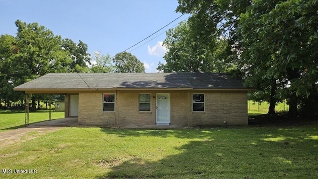 210 Ford St, Como, MS 38619 - view of front of home featuring concrete driveway, an attached carport, brick siding, and a front yard
