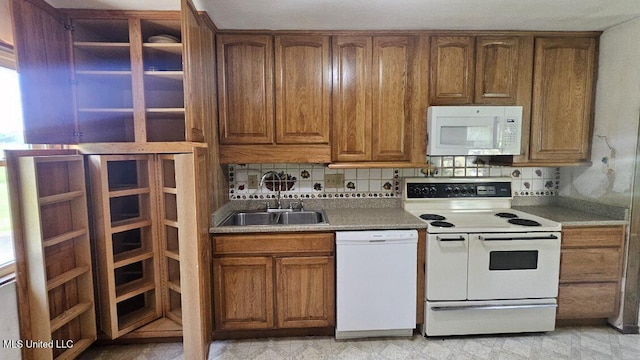 210 Ford St, Como, MS 38619 - kitchen with white appliances, brown cabinetry, and decorative backsplash