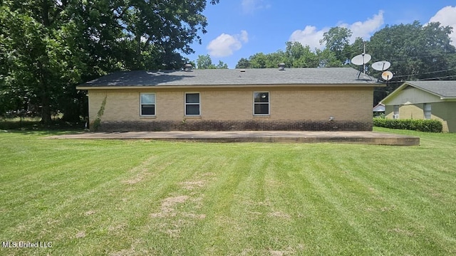 210 Ford St, Como, MS 38619 - back of house with brick siding and a yard