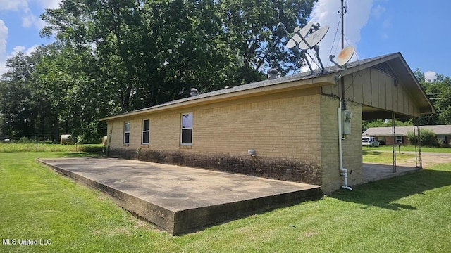 210 Ford St, Como, MS 38619 - view of property exterior with brick siding and a yard