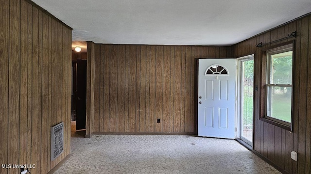 210 Ford St, Como, MS 38619 - carpeted foyer featuring wooden walls and healthy amount of natural light