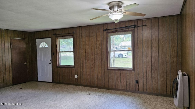 210 Ford St, Como, MS 38619 - entryway with plenty of natural light, heating unit, wood walls, and ceiling fan
