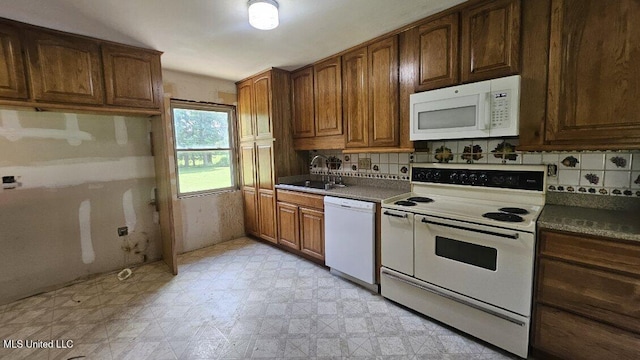 210 Ford St, Como, MS 38619 - kitchen featuring white appliances, light floors, backsplash, and dark countertops