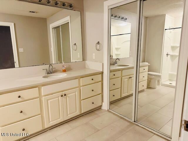 bathroom featuring tile patterned floors, vanity, and toilet