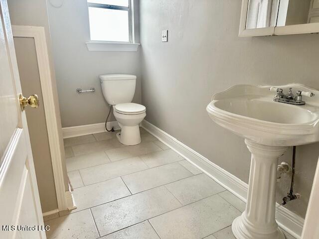 bathroom with sink, tile patterned flooring, and toilet