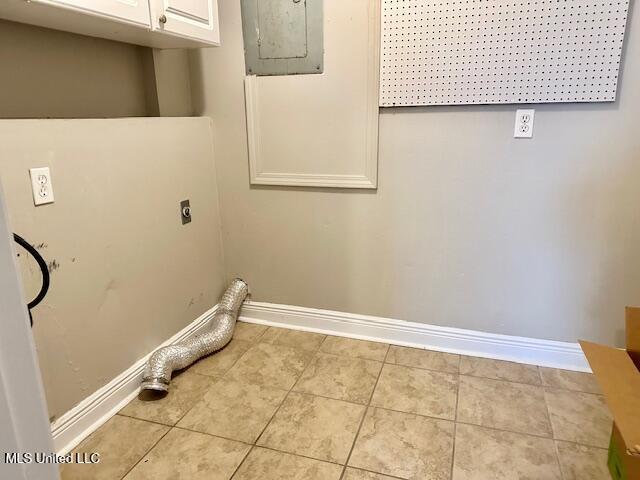 washroom with hookup for an electric dryer, light tile patterned flooring, cabinets, and electric panel