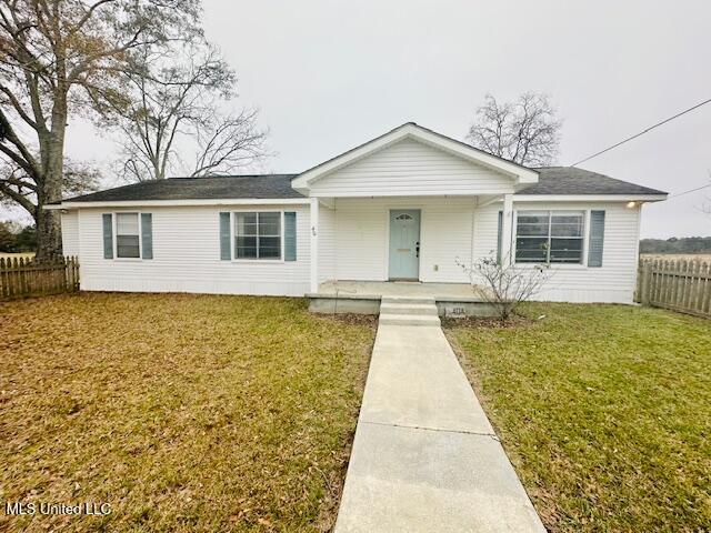 ranch-style house with covered porch and a front lawn