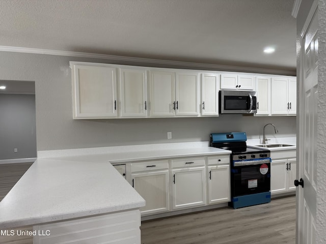 kitchen with white cabinetry, sink, ornamental molding, light hardwood / wood-style floors, and stainless steel appliances