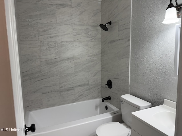 full bathroom with vanity, tiled shower / bath, and toilet