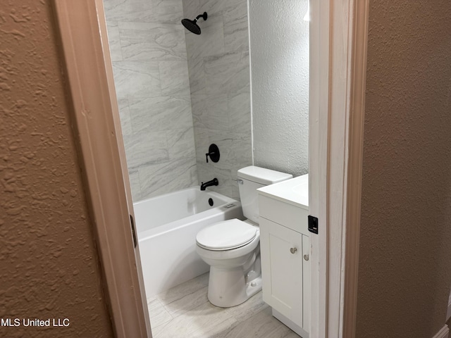 full bathroom featuring vanity, tiled shower / bath combo, and toilet