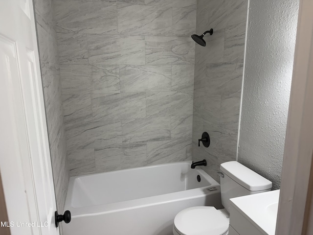 full bathroom featuring tiled shower / bath, vanity, and toilet