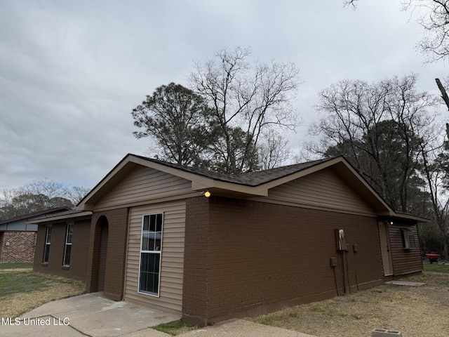 view of side of home with a patio