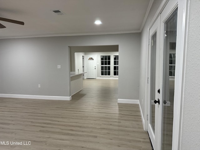 hall with crown molding and light wood-type flooring