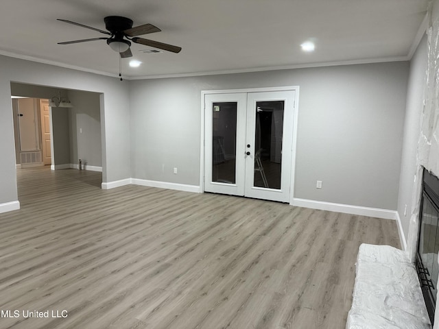 unfurnished living room with ornamental molding, ceiling fan, light wood-type flooring, and french doors