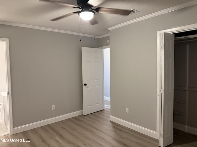 unfurnished bedroom featuring crown molding, light hardwood / wood-style flooring, and ceiling fan