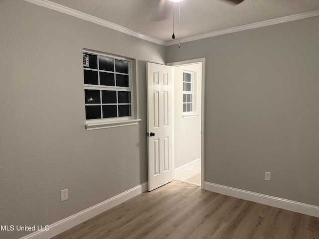 unfurnished room with hardwood / wood-style flooring, ceiling fan, and ornamental molding