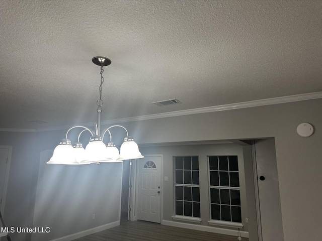 details featuring ornamental molding and a textured ceiling