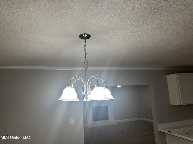 details with wood-type flooring, ornamental molding, and a textured ceiling