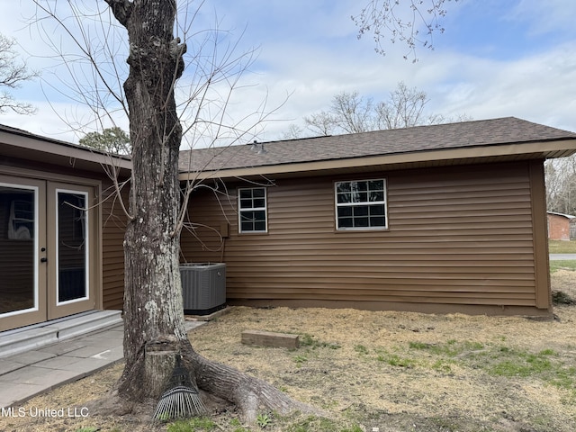 view of home's exterior with central AC and french doors