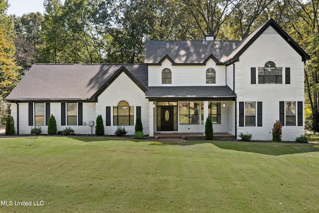 3555 Bonner Dr, Olive Branch, MS 38654 - view of front of home with a chimney, a shingled roof, a front yard, a porch, and brick siding