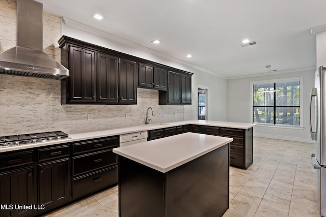 kitchen with wall chimney range hood, backsplash, a kitchen island, stainless steel appliances, and decorative light fixtures