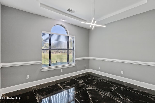 3555 Bonner Dr, Olive Branch, MS 38654 - unfurnished room featuring marble finish floor, visible vents, a raised ceiling, and baseboards