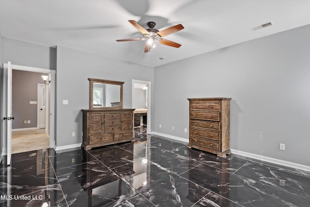 bedroom with ceiling fan and ensuite bath