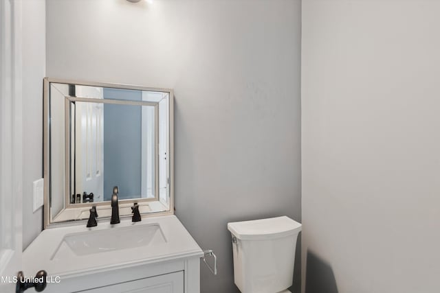 bathroom with vanity and toilet