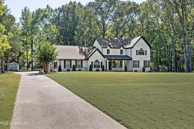 3555 Bonner Dr, Olive Branch, MS 38654 - modern farmhouse style home with a chimney, brick siding, a shingled roof, an outbuilding, and a front yard