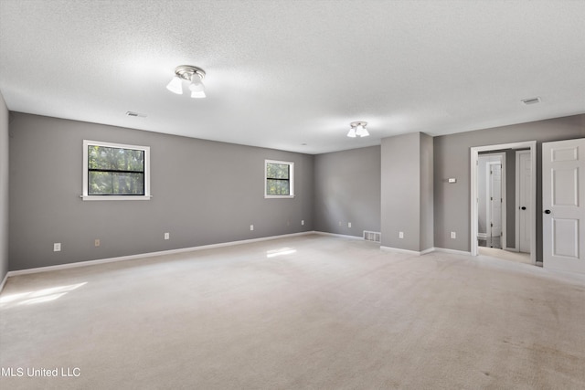 3555 Bonner Dr, Olive Branch, MS 38654 - empty room featuring baseboards, visible vents, light carpet, and a textured ceiling