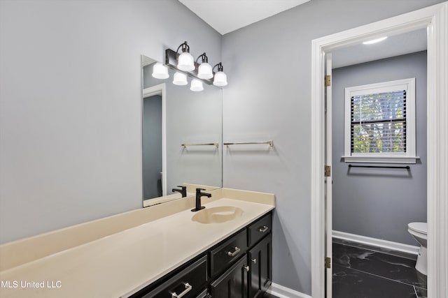 bathroom with vanity and toilet