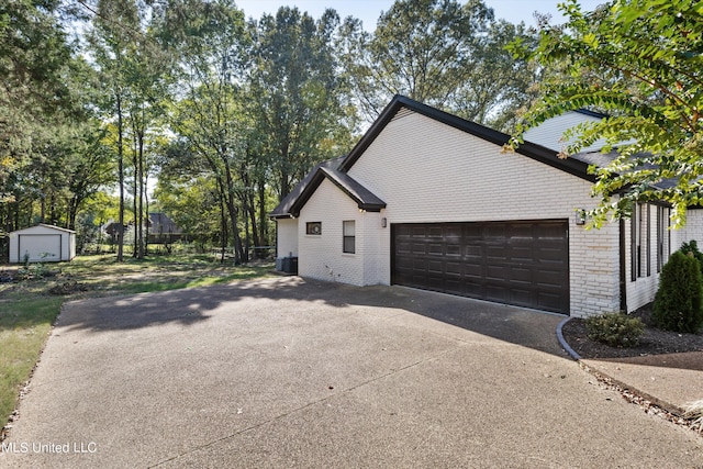 view of home's exterior with cooling unit and a garage