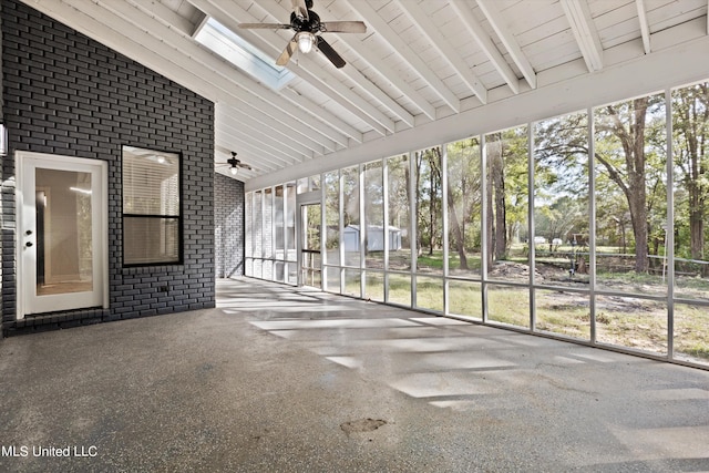 unfurnished sunroom with vaulted ceiling with skylight and ceiling fan