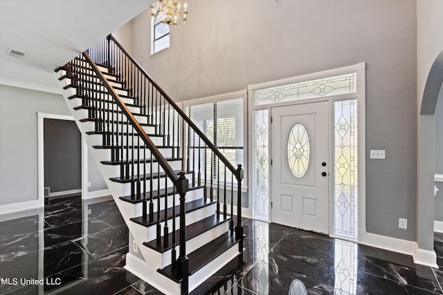 entrance foyer with a notable chandelier and a high ceiling