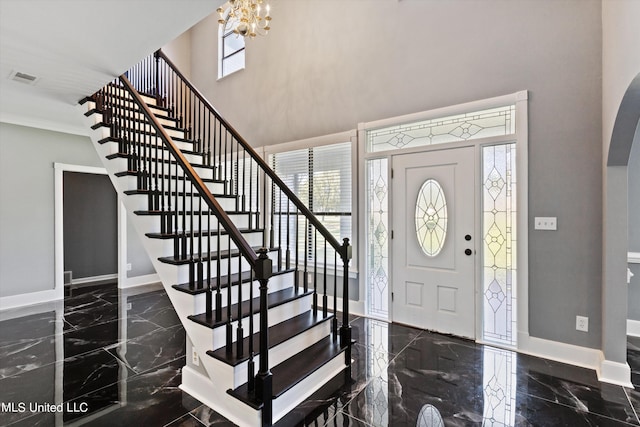 3555 Bonner Dr, Olive Branch, MS 38654 - entrance foyer featuring marble finish floor, arched walkways, stairs, and baseboards