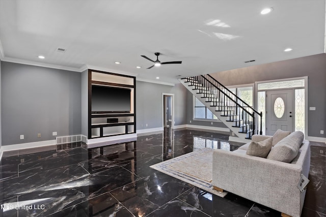 living room with ornamental molding and ceiling fan