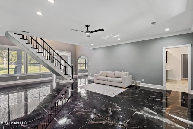 living room with crown molding and ceiling fan