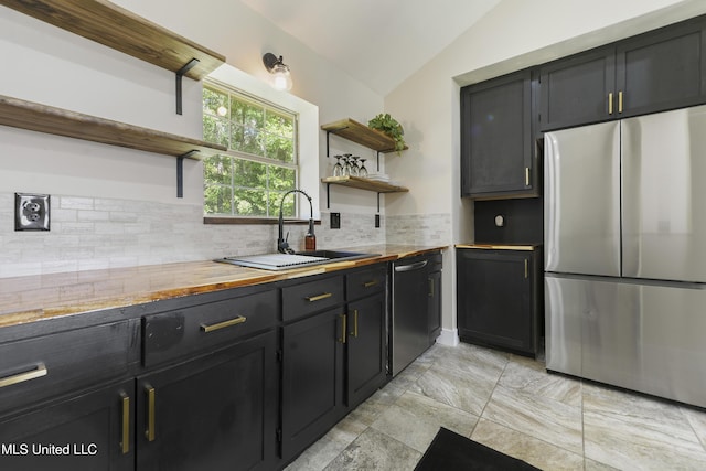 kitchen featuring open shelves, freestanding refrigerator, wooden counters, and dishwasher