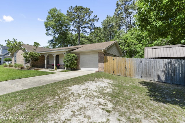 view of front of home with driveway, brick siding, fence, a front lawn, and an attached garage