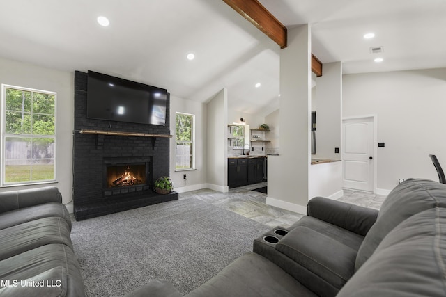 living room featuring visible vents, a brick fireplace, baseboards, lofted ceiling with beams, and recessed lighting
