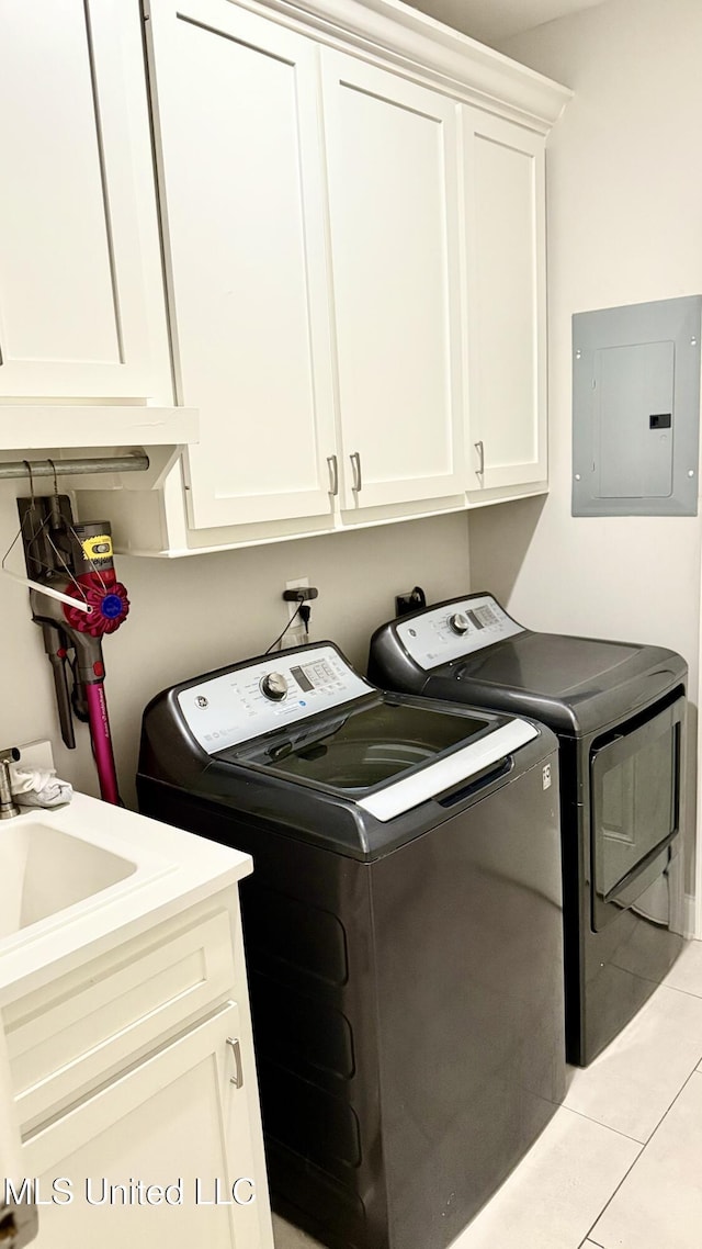 580 Hickory Pl, Brandon, MS 39047 - laundry area with electric panel, washer and clothes dryer, cabinet space, and light tile patterned floors