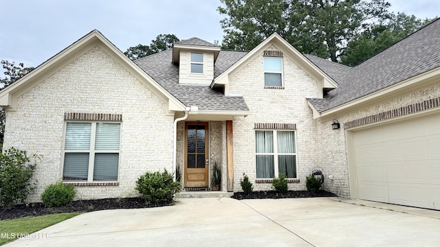 580 Hickory Pl, Brandon, MS 39047 - view of front facade featuring a shingled roof, concrete driveway, an attached garage, and brick siding