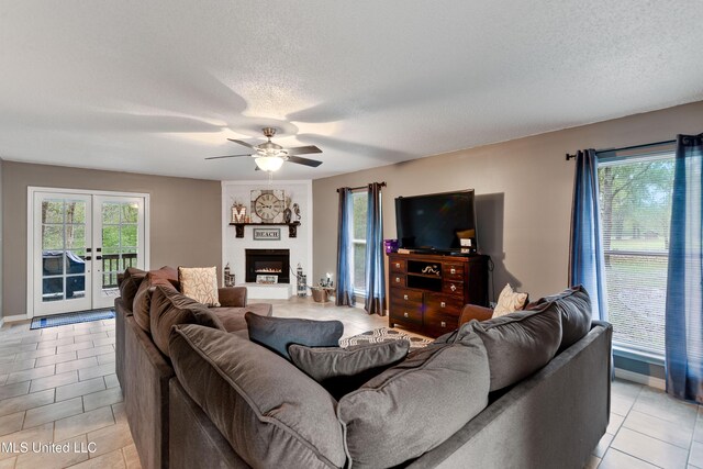 1160 Lucas Rd, Lucedale, MS 39452 - living area featuring a ceiling fan, light tile patterned floors, plenty of natural light, a textured ceiling, and baseboards