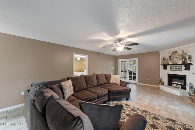 1160 Lucas Rd, Lucedale, MS 39452 - living area featuring a ceiling fan, baseboards, a brick fireplace, light stone finish flooring, and a textured ceiling