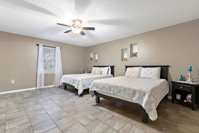 1160 Lucas Rd, Lucedale, MS 39452 - bedroom with baseboards, a ceiling fan, and a textured ceiling