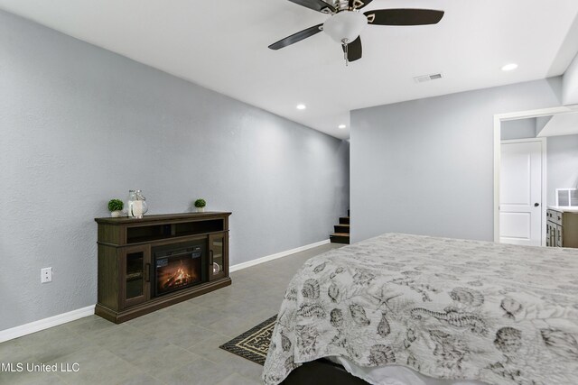 1160 Lucas Rd, Lucedale, MS 39452 - bedroom with baseboards, recessed lighting, a ceiling fan, and a glass covered fireplace